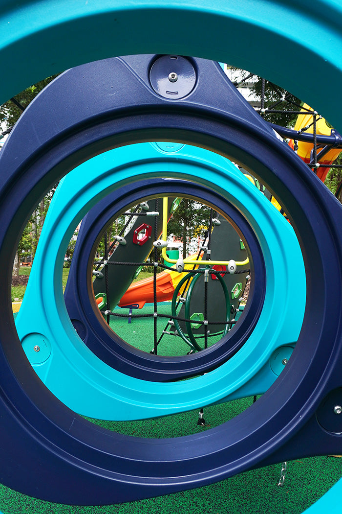 Hurricane Bridge Climber, an equipment with suspended rings that sway as children navigate it, providing a dynamic play.