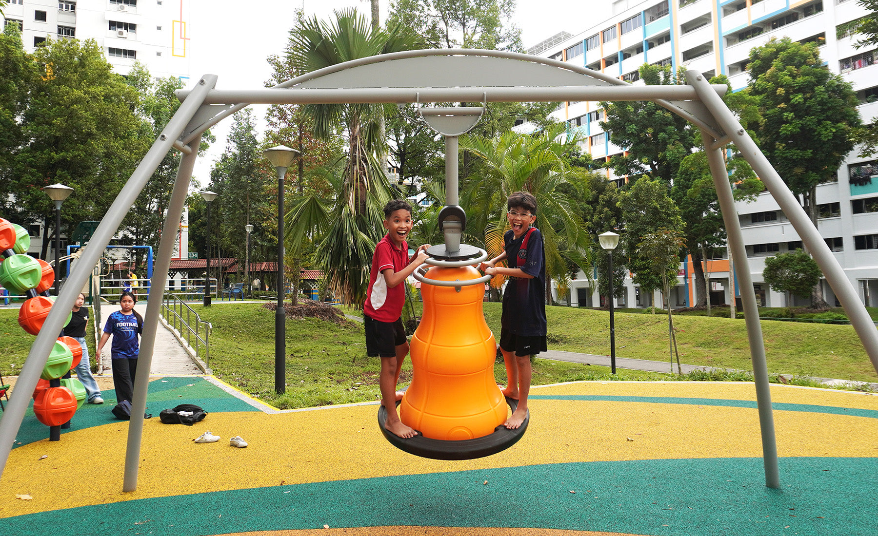 HAGS Bell Swing, where children climb the base and use handlebars to sway, spin or rotate the bell structure safely.