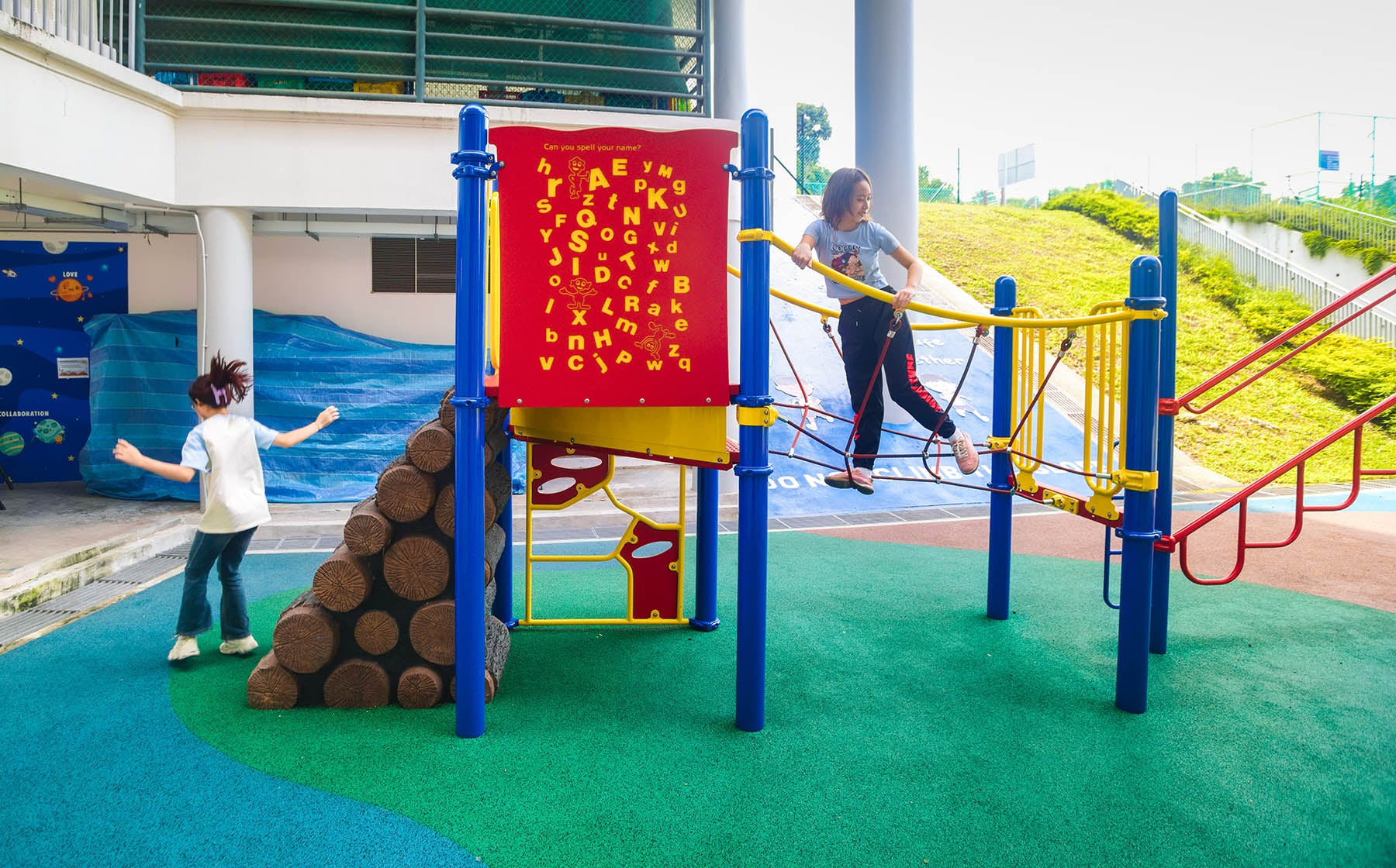 ACS (Junior) Playworld playground features creative play panels and varied climbing structures, encouraging active play.
