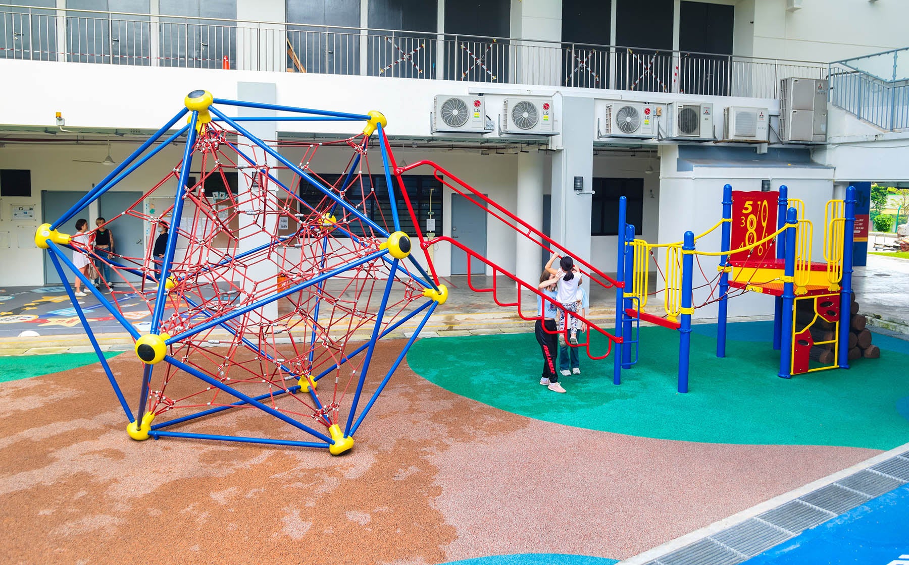 ACS (Junior) playground with Berliner Spaceball, Playworld play panels, and climbers for safe, fun, and active play.