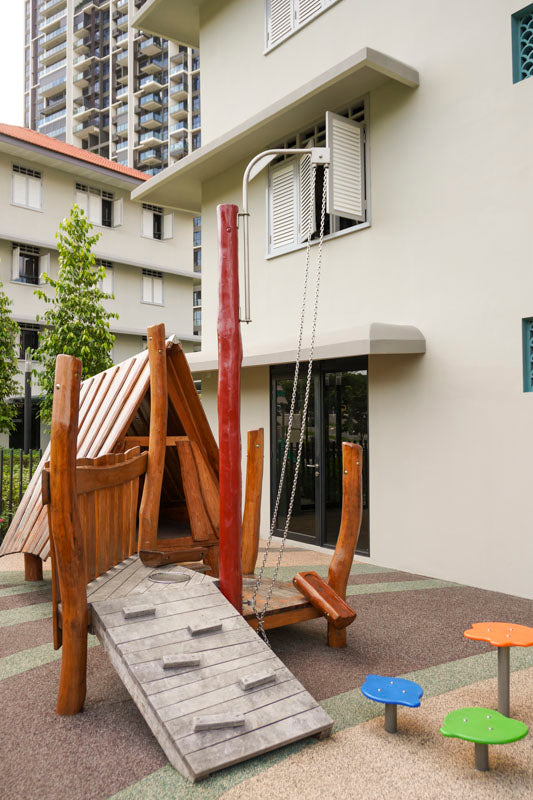 Playground with a small obstacle structure, designed for little children to climb, and crawl in a safe environment.