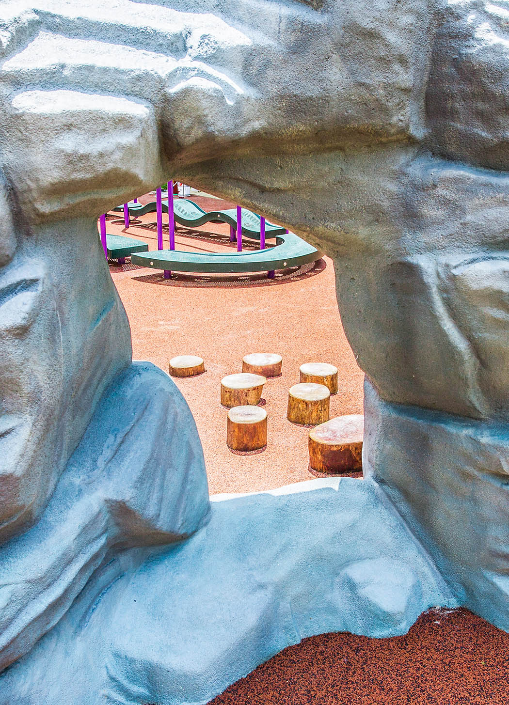 Playworld playground equipment with a cave-like structure allows children to explore and satisfy their curiosity.