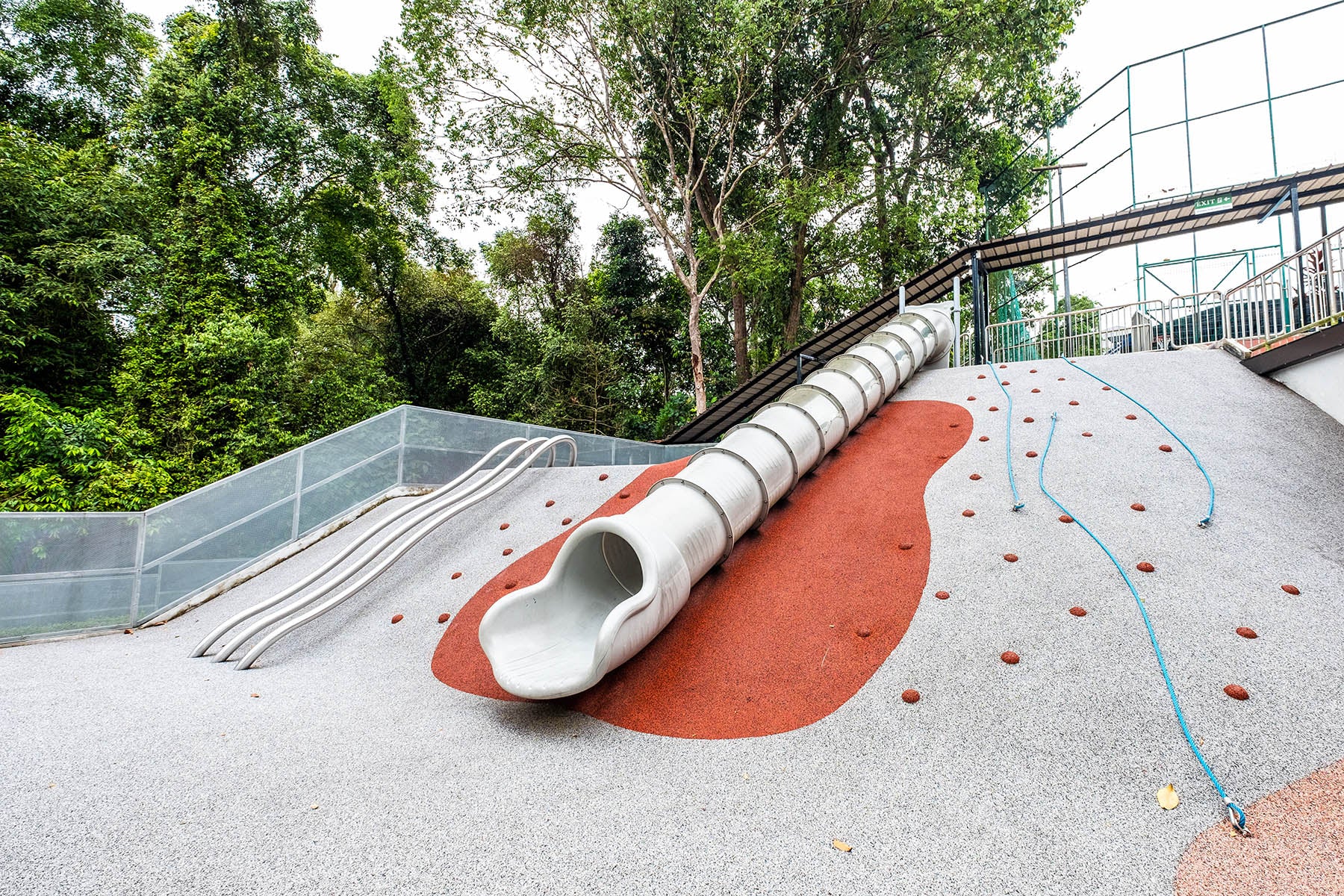 Chatsworth International School playground featuring a hilltop slide, accessible via various climbing routes for kids.