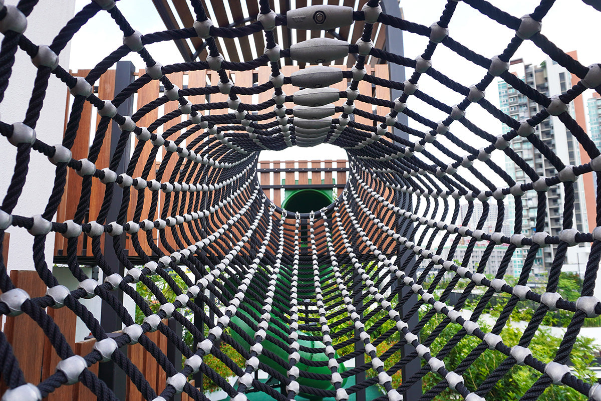Jervois Mansion playground features a durable rope tunnel that connects play towers for safe climbing and adventure.