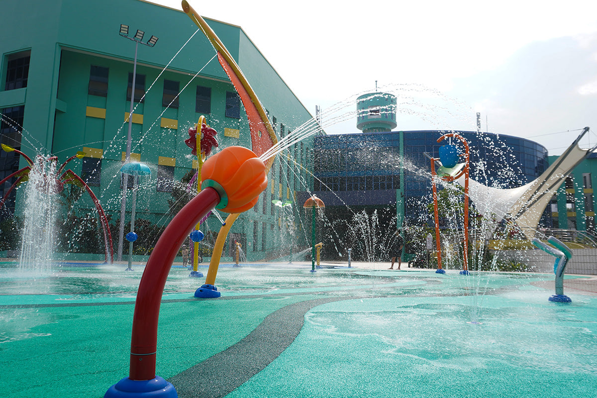 Jurong East Swimming Complex features vibrant outdoor water play equipment that releases huge streams of water.