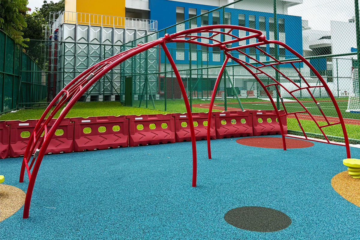 Jurong Primary School playground features an arched bar climber to challenge students' strength and coordination safely.