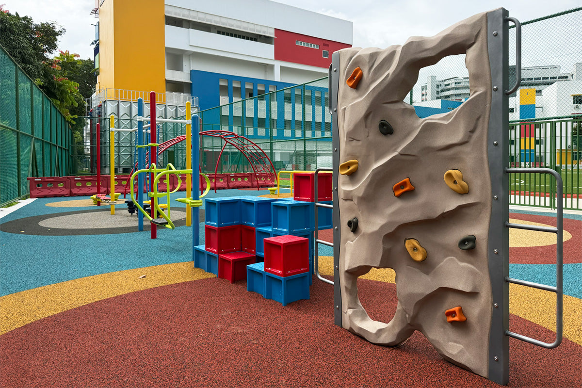 Jurong Primary School playground features climbing squares and a rock wall to safely challenge students' coordination.