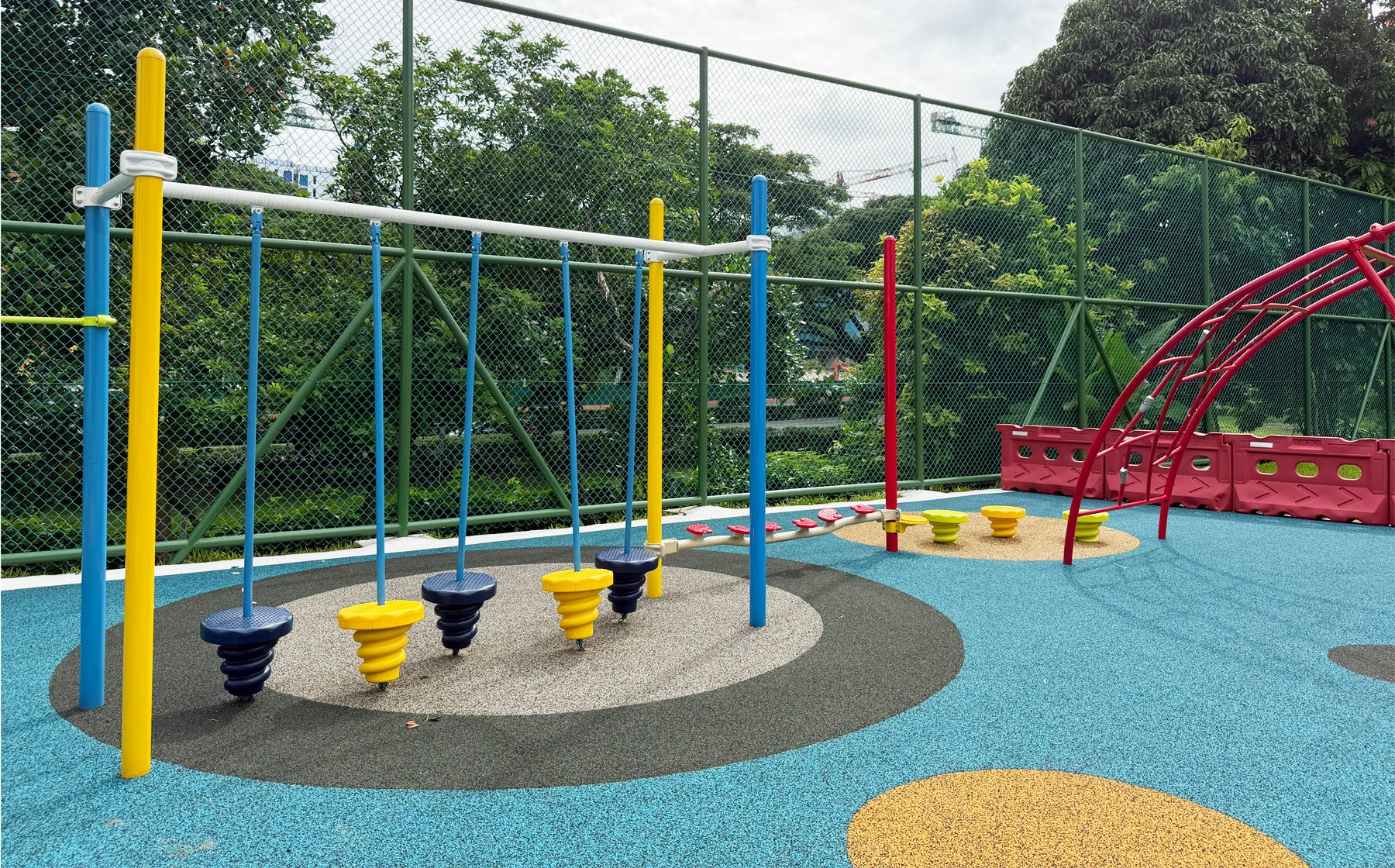 Jurong Primary School playground offers sturdy equipment for students to develop hand-eye coordination skills safely.