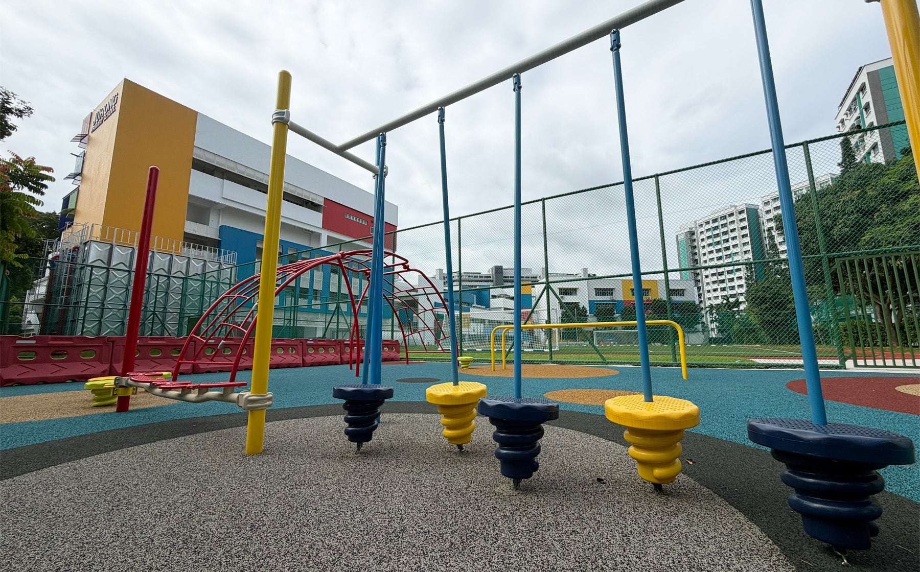 Jurong Primary School playground offers sturdy equipment for students to develop hand-eye coordination skills safely.