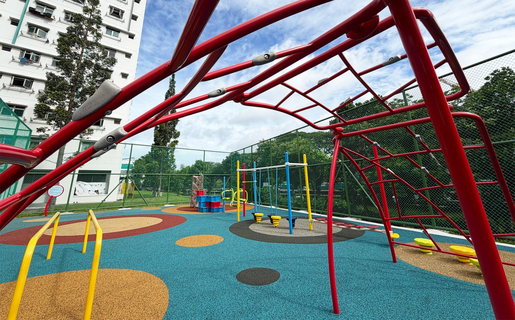 Jurong Primary School playground features an arched bar climber to challenge students' strength and coordination safely.