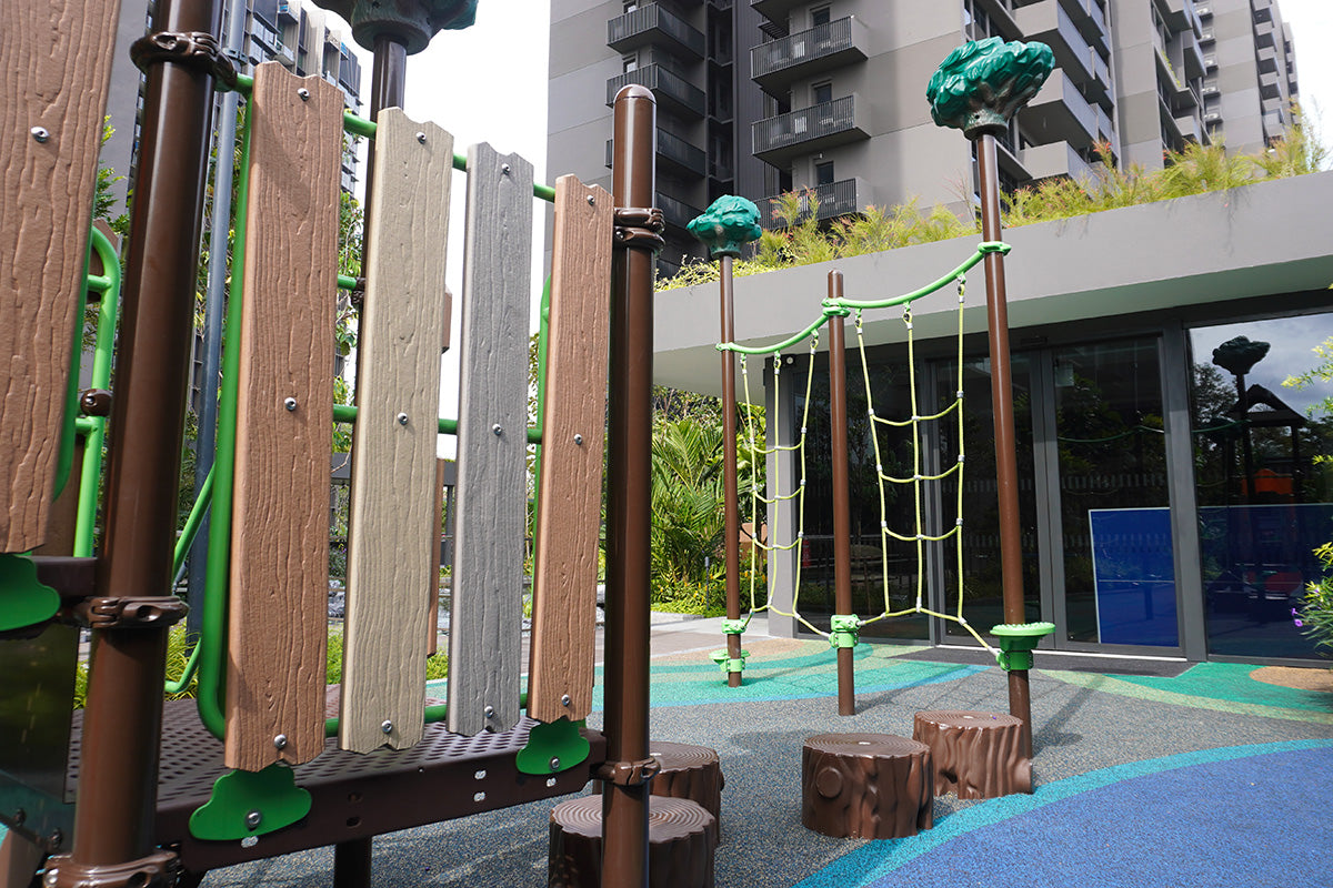 Lentor Modern rope play structure with tree stump stepping pods designed to support balance, climbing and coordination.