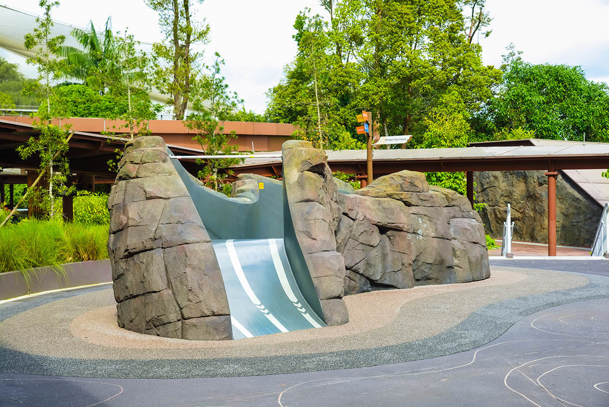 Pangolin-inspired rock sculpture with integrated slide, combining nature's beauty and safe, engaging play for children.