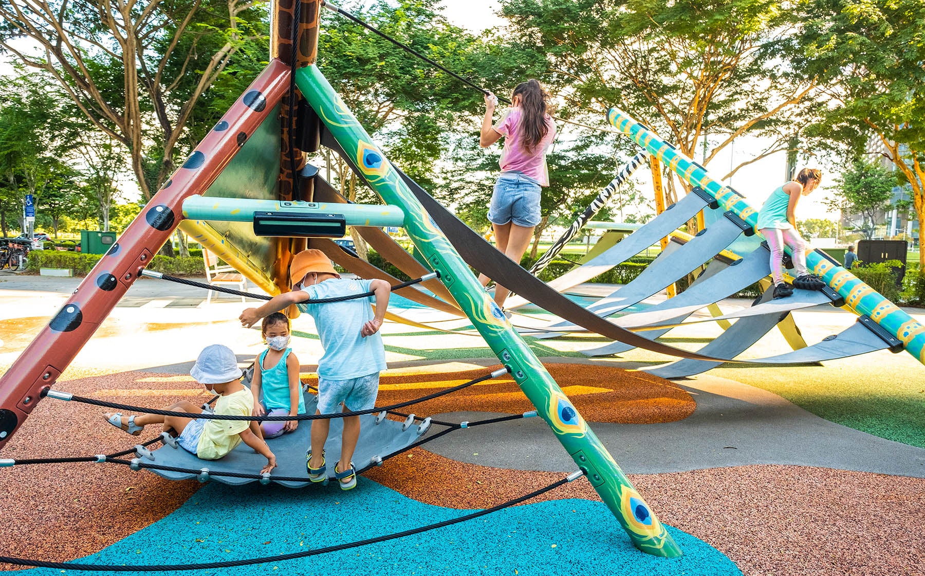 Children enjoying the Playworld PlayForm 7 playground, climbing the structure and resting on its interactive design elements.