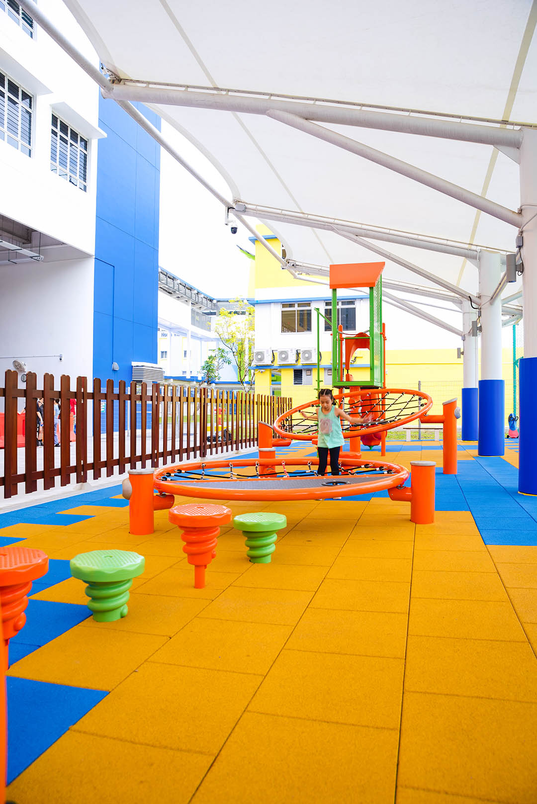 Shaded playground with Playworld infiNET, providing barrier-free platform nets and versatile climbing challenges.