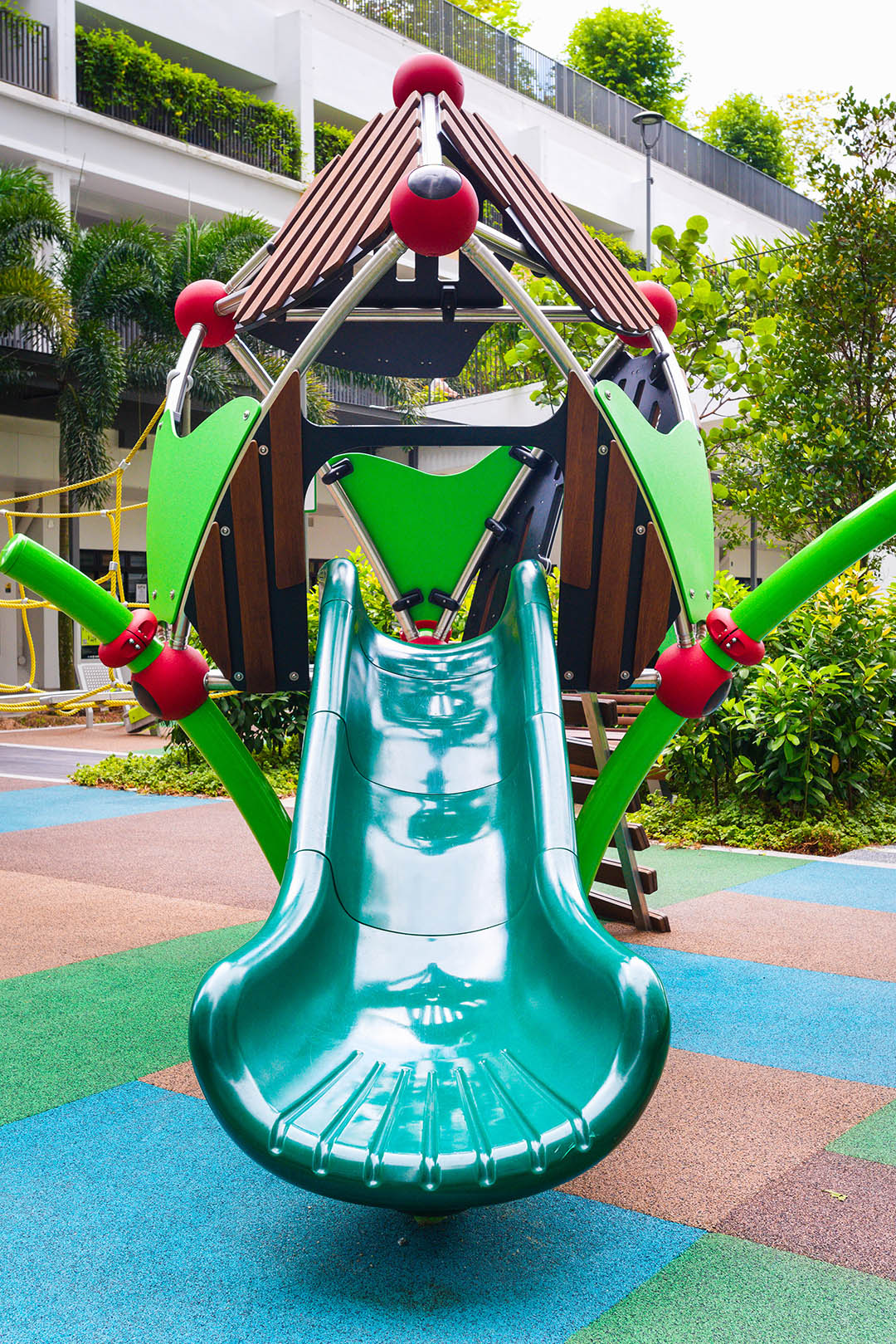 The Berliner treehouse playground with a slide offers children a fun and thrilling descent for active play.