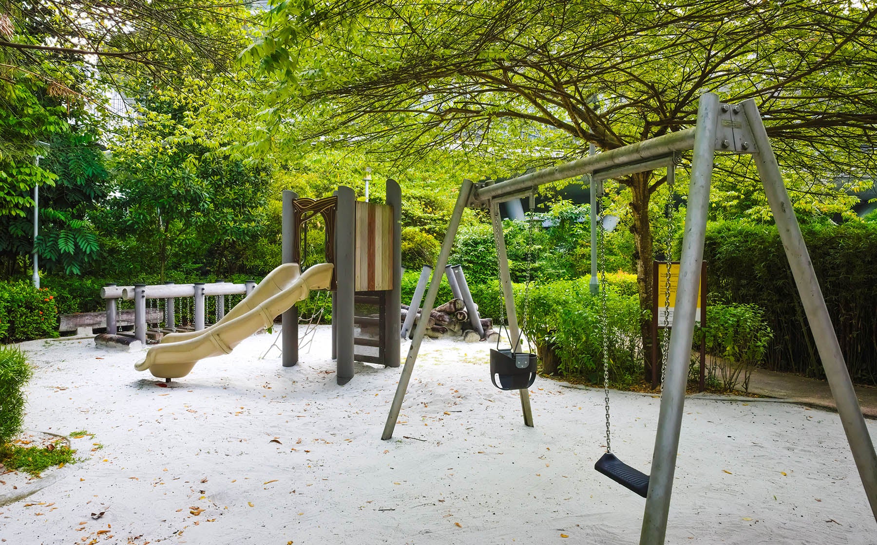 one-north Park nature playground with a rope climb, slide, and swing, offering fun and active play for children.