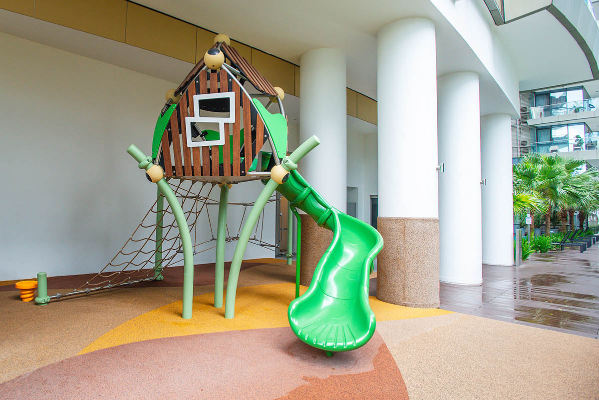 One Shenton playground featuring Berliner Greenville with a rope net and slide for active outdoor play.