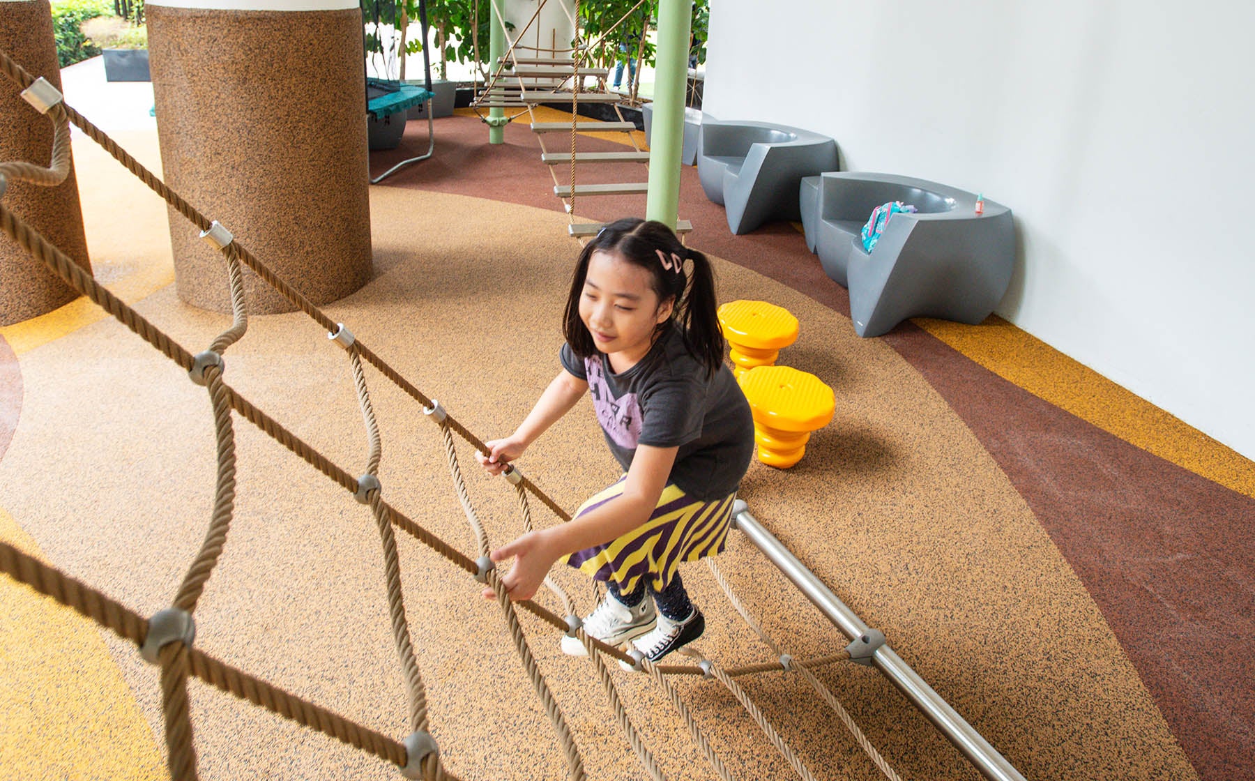 One Shenton playground featuring Berliner Greenville with a rope net and slide for active outdoor play.