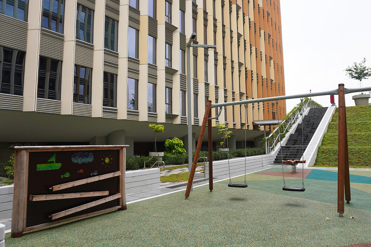 Punggol Digital District playground features swings and a play panel with wooden ramps, educating children about force.
