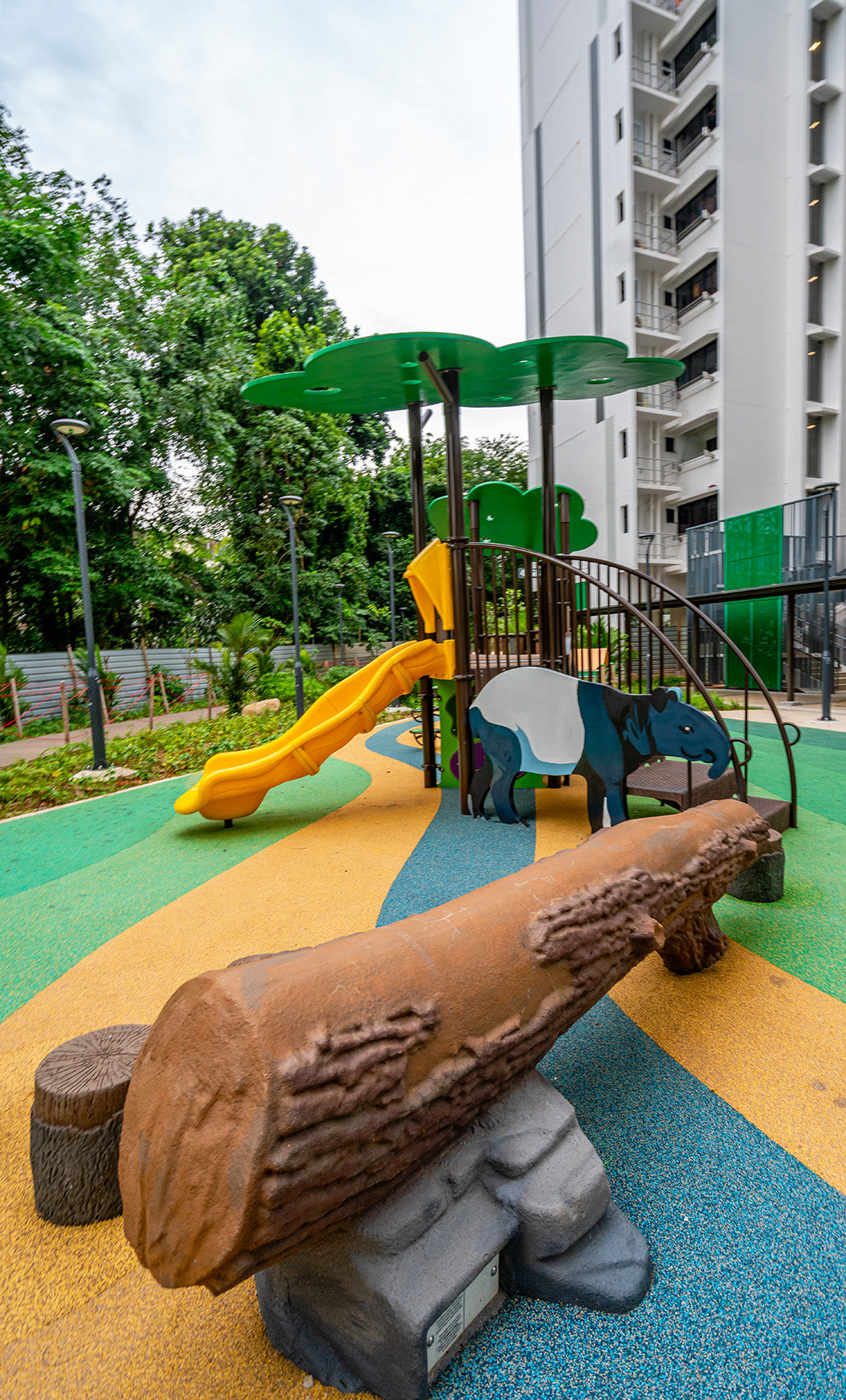Punggol Point Crown animal-themed playground with balancing log and Tapir panel for sensory and motor skill development.