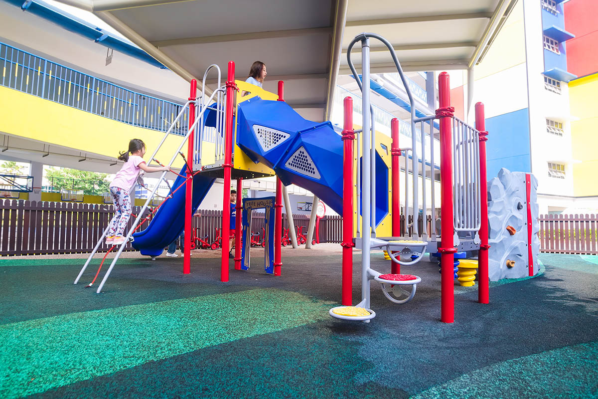 Children having fun at the Playworld playground, climbing and sliding with excitement.