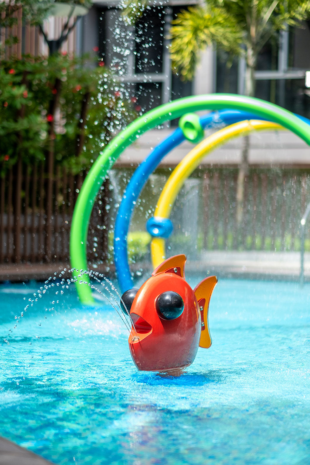 Water playground featuring a playful fish element spraying water, providing fun and refreshing play for children.