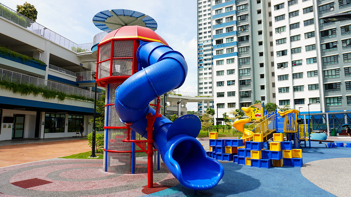 Lighthouse Tower playground with climbing features, a relaxing hammock, and an exciting spiral slide for active play.