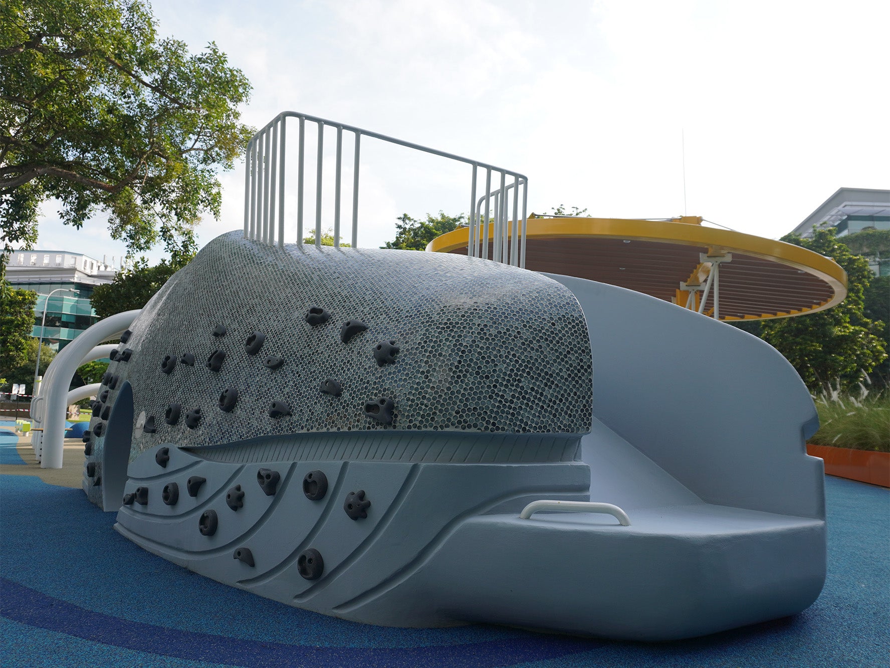 Whale playground head at National Museum Singapore features a slide with a handle bar for safe wheelchair access.