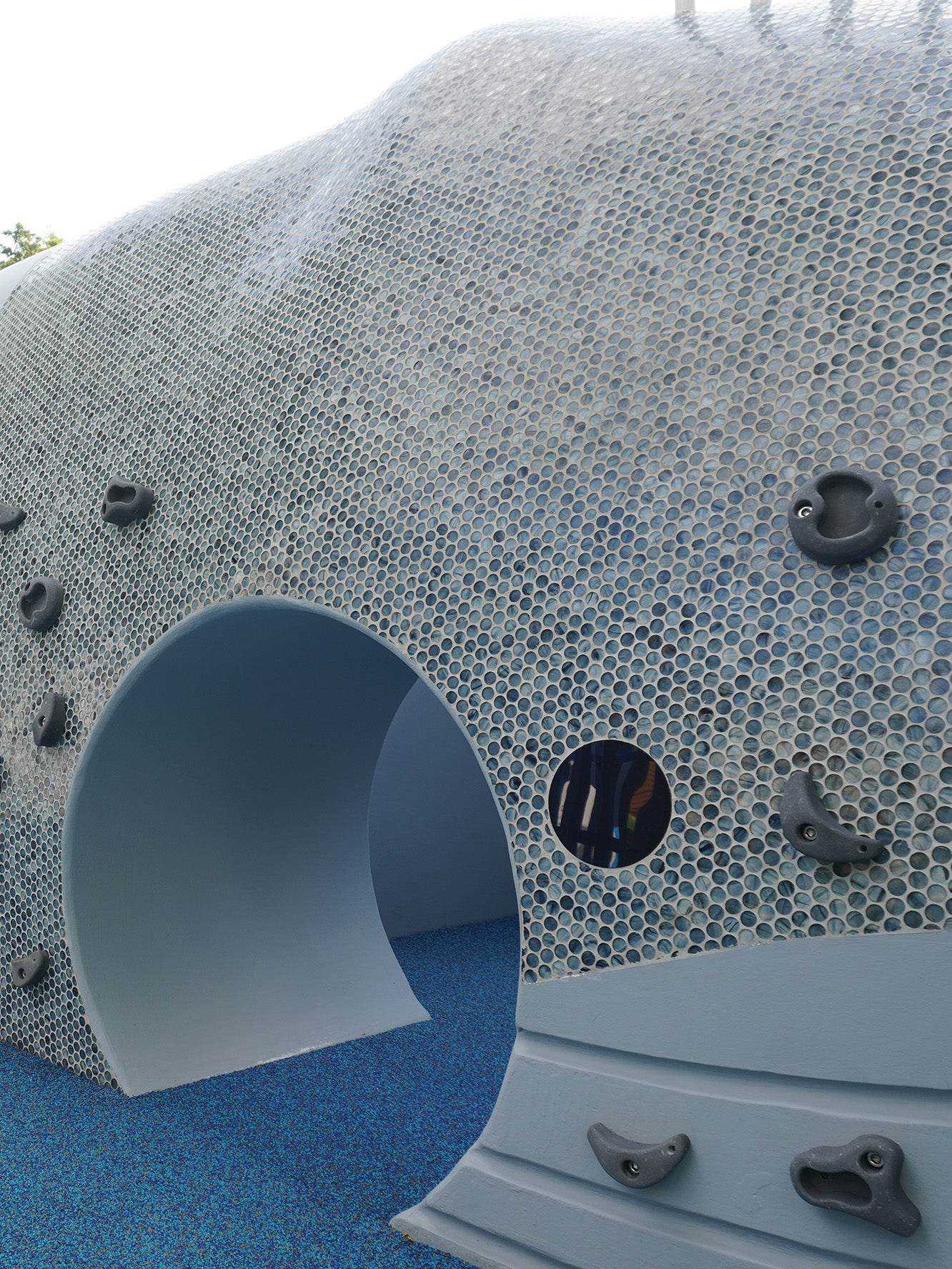 The Whale of a Tale playground head features a tunnel for children to crawl through and explore safely.