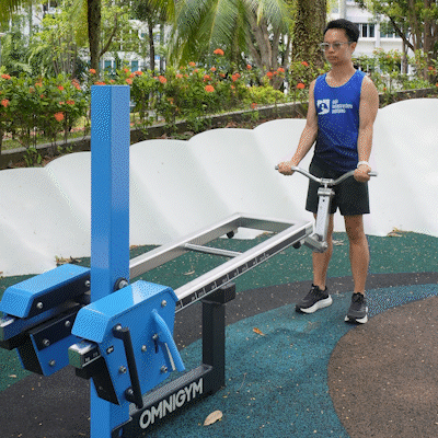 Omnigym bicep curl machine with adjustable resistance for controlled arm strengthening and outdoor fitness.