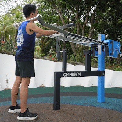 Omnigym squat machine with adjustable weights for compound leg and glute strength-building exercises outdoors daily.