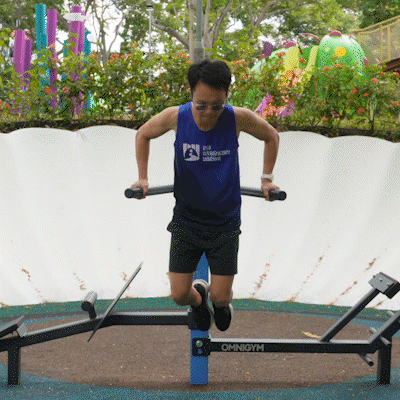 Omnigym tricep dip machine builds upper body strength using body weight for controlled outdoor workouts.