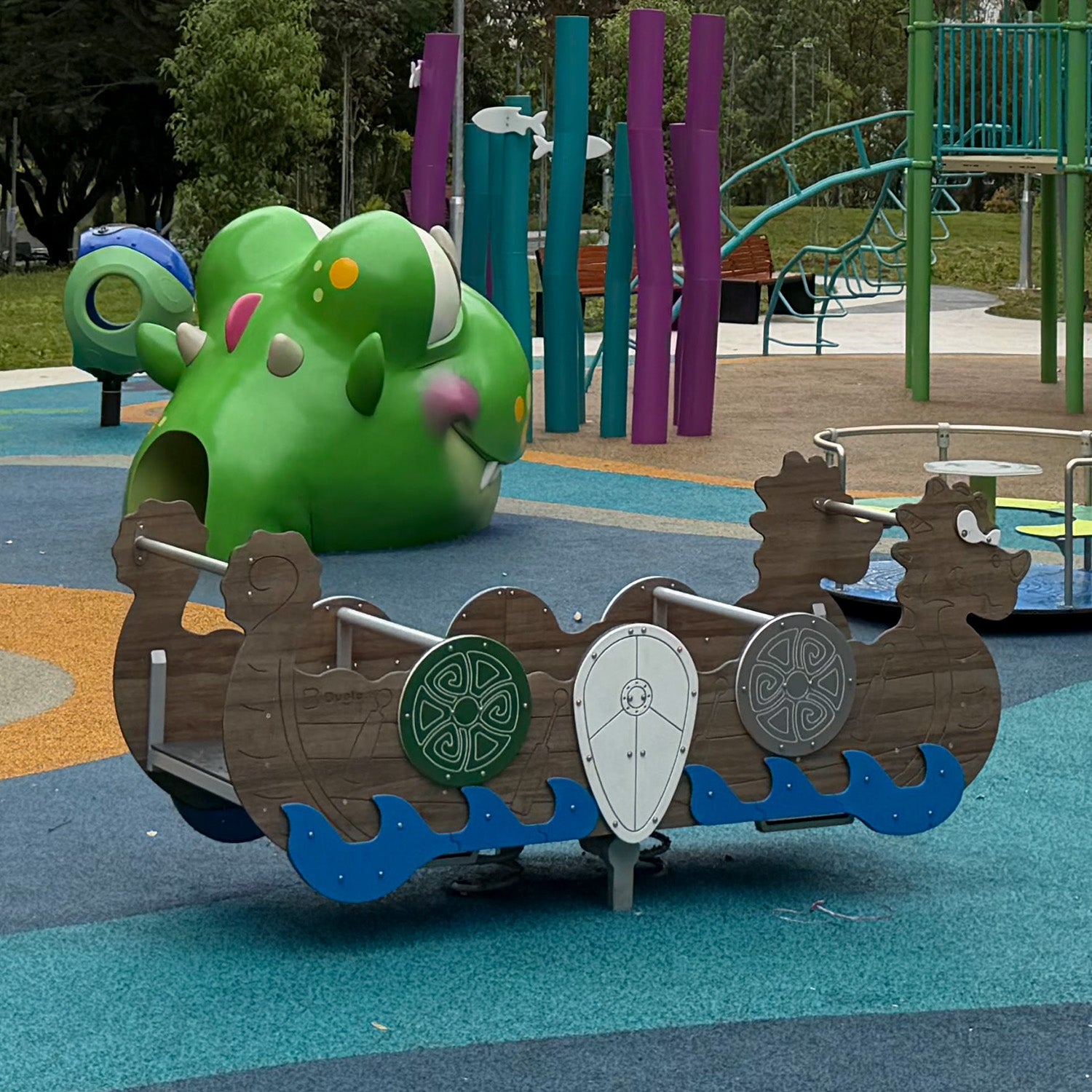 Sea Shell Park playground features a Multi-Seat Rocker designed to resemble a Viking ship, providing safe group play.