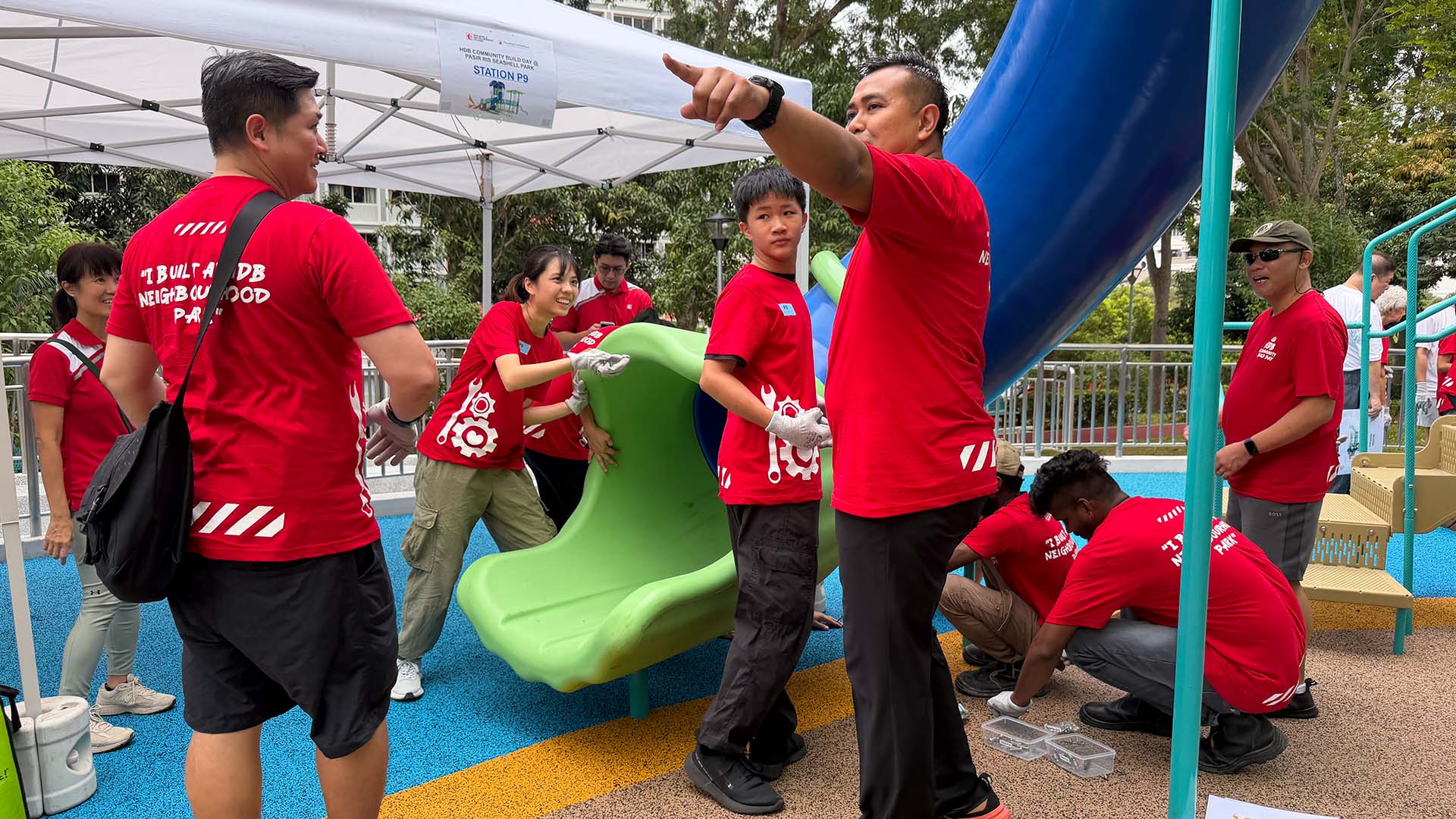 Pasir Ris residents and their MP Sharael Taha join to build playground slides, fostering community and active fun.