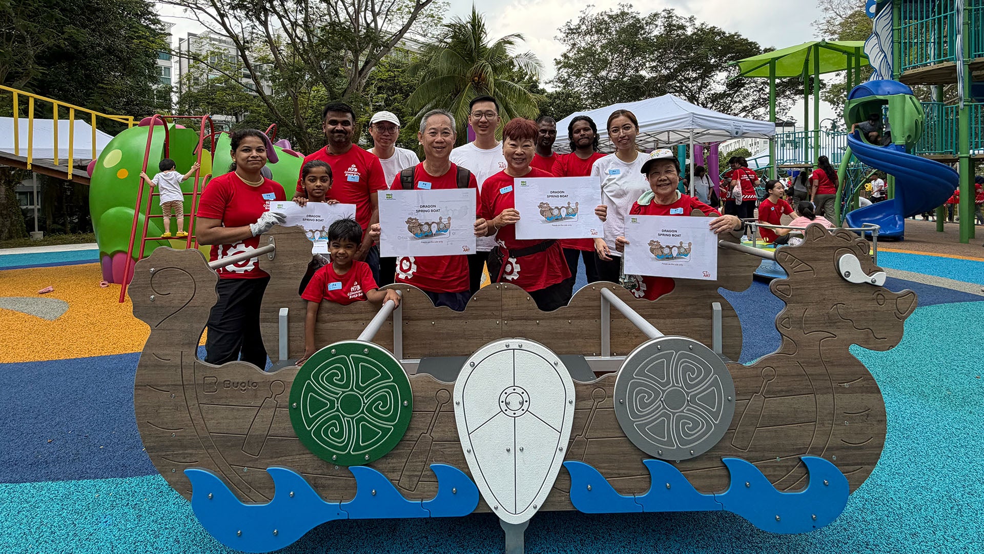 Pasir Ris residents smile proudly at the finished Dragon-themed Multi-Seat Spring Rocker, ready for fun play.