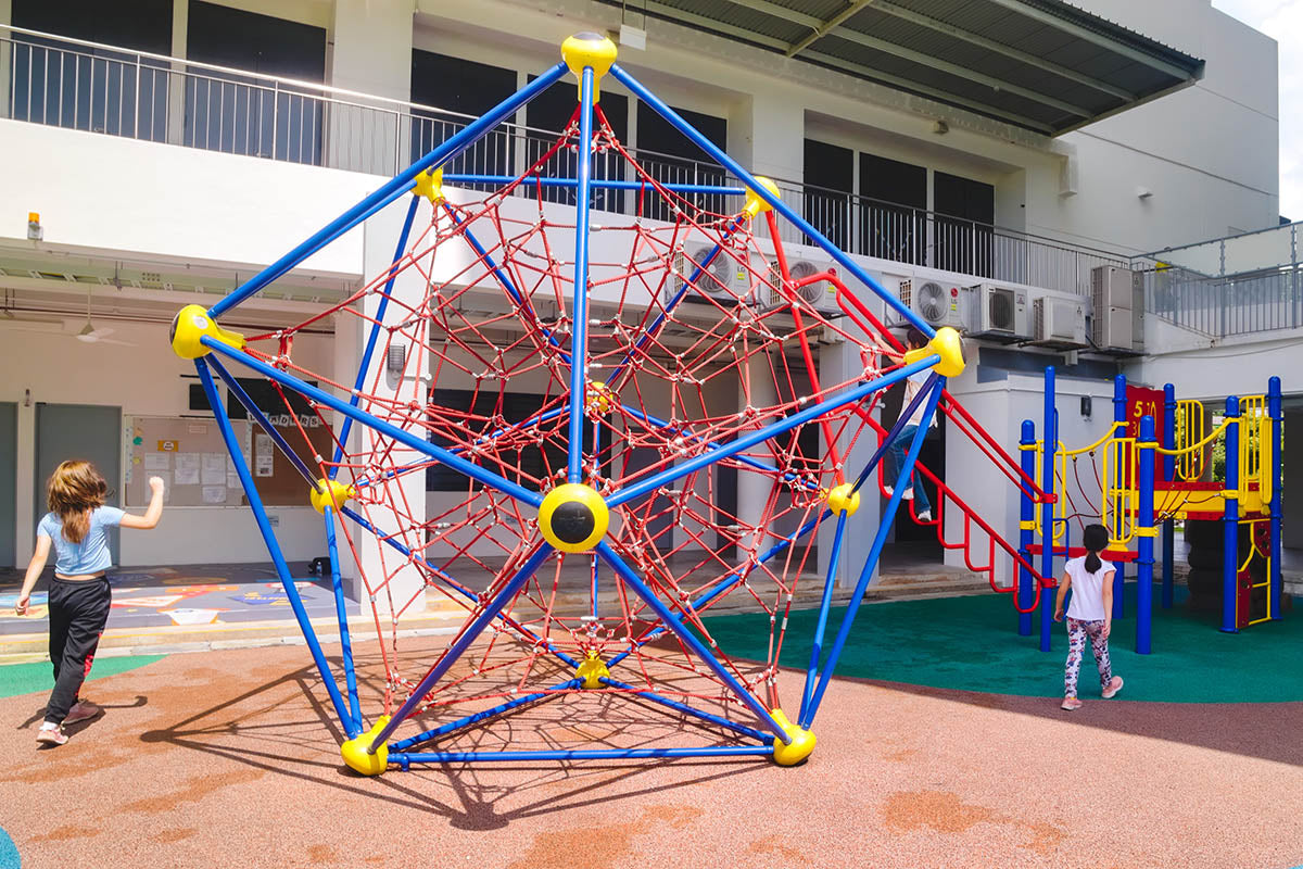 ACS (Junior) playground features Berliner Spaceball and Playworld linked by a swaying rope bridge, fostering safe play.