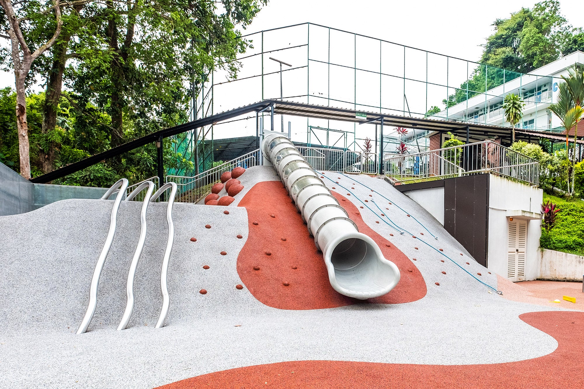 Chatsworth International School playground featuring a hilltop slide, accessible via various climbing routes for kids.