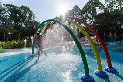 Jacob Ballas Children's Garden with Vortex International rainbow arches pour refreshing water down for kids to enjoy.