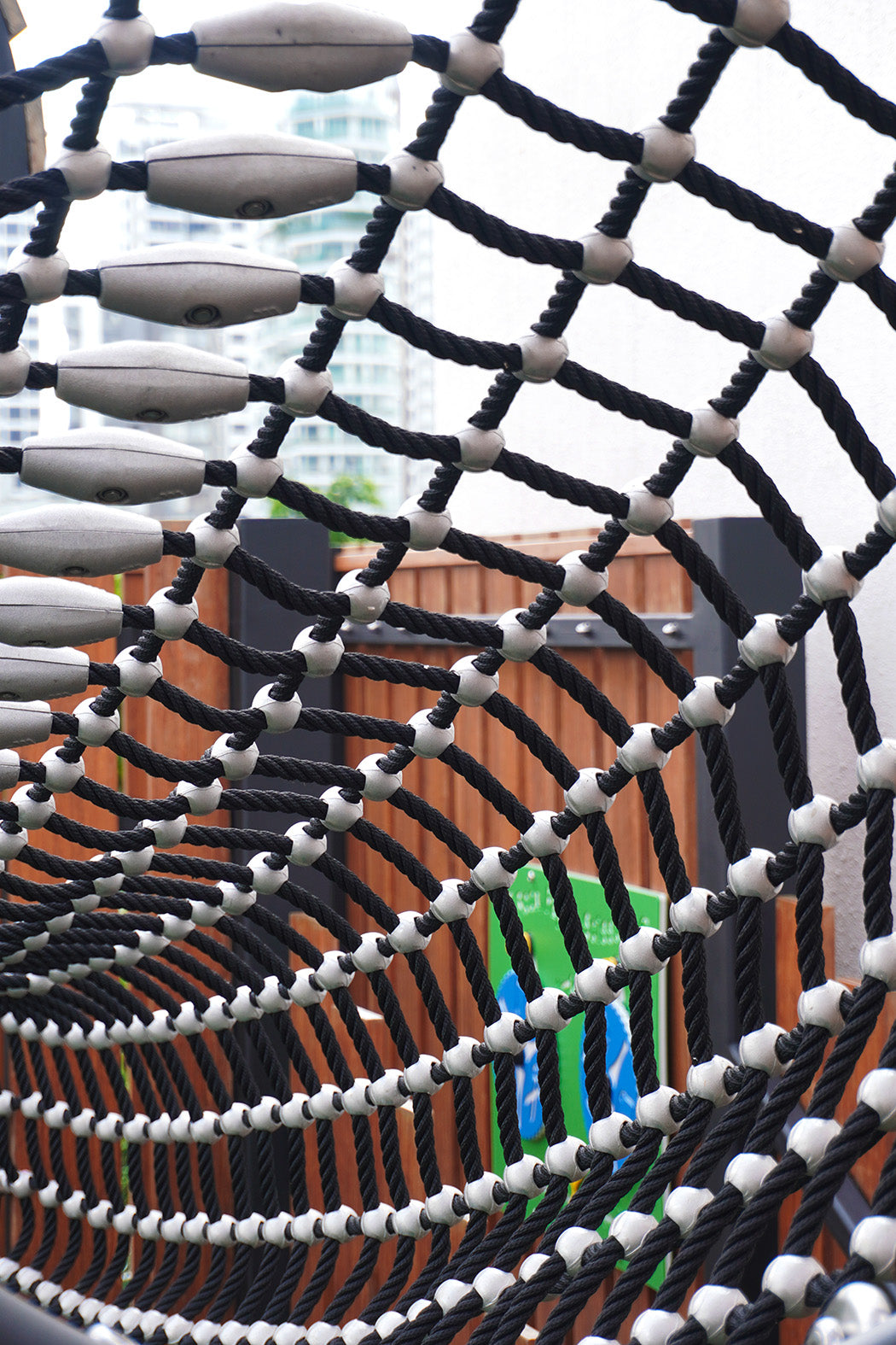 Jervois Mansion playground features a durable rope tunnel that connects play towers for safe climbing and adventure.