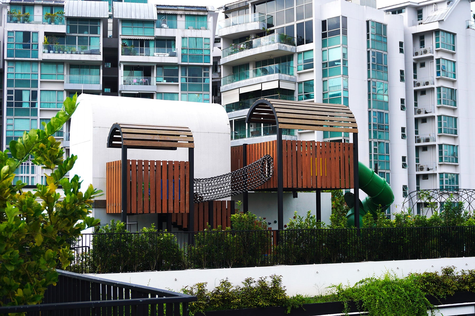 Jervois Mansion playground features elevated play towers linked by a rope tunnel, slide and shaded play decks.