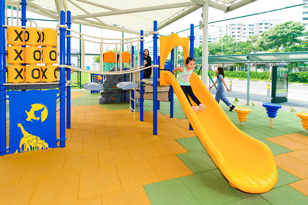 Shaded Playworld playground featuring a slide and a tic-tac-toe play panel, promotes fun, creativity, and social play.