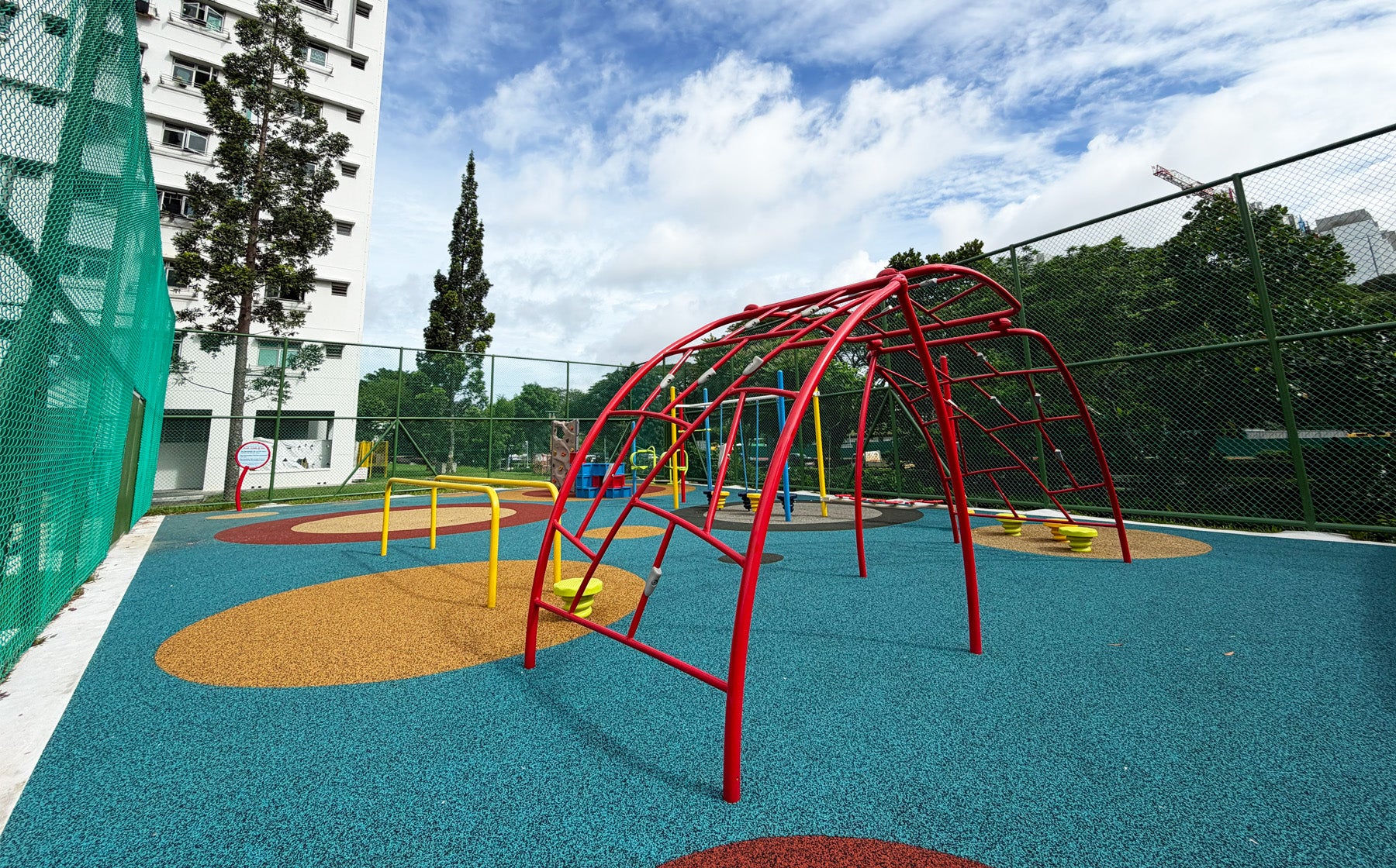 Jurong Primary School playground features an arched bar climber to challenge students' strength and coordination safely.