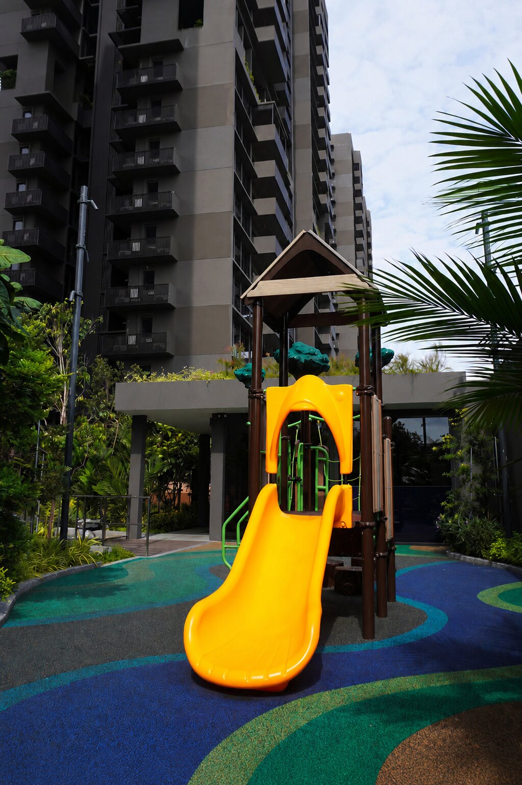Lentor Modern playground features a bright yellow slide designed for exciting and safe outdoor play fun.
