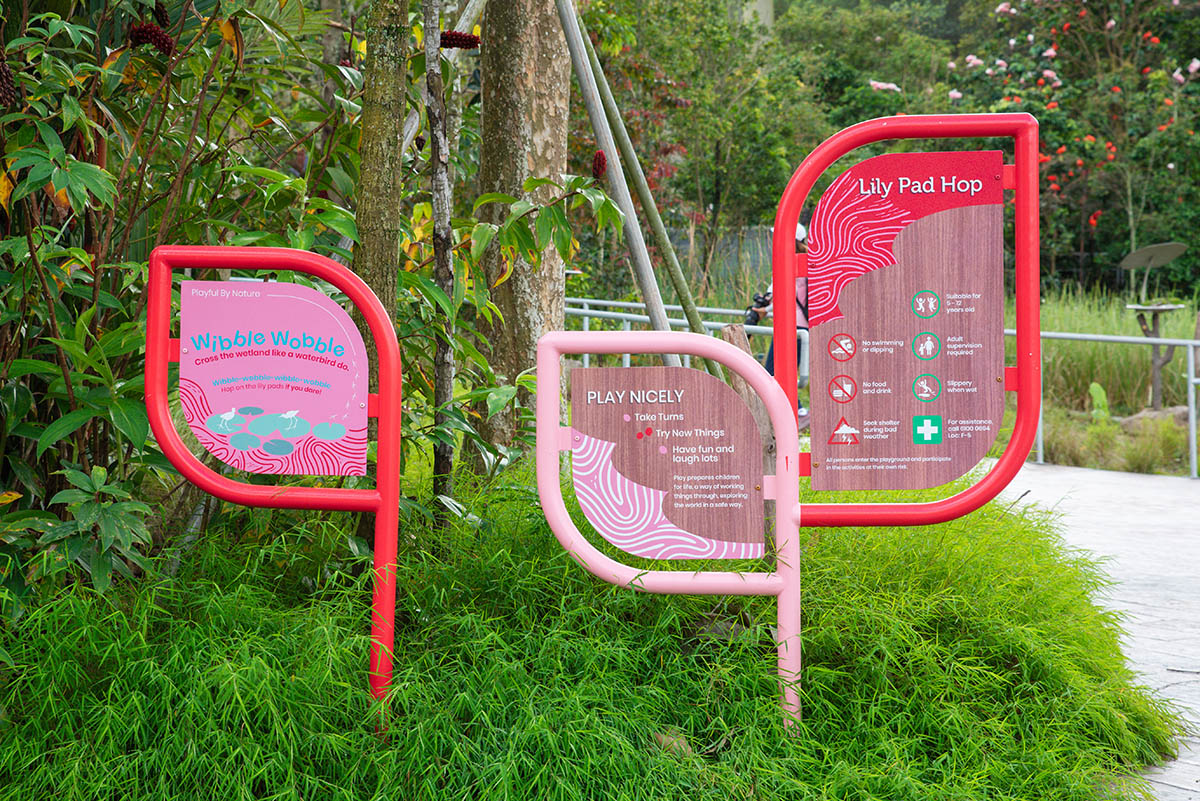 Mandai Bird Paradise signboard marks the Crimson Wetlands Play Pocket, featuring engaging playground equipment.