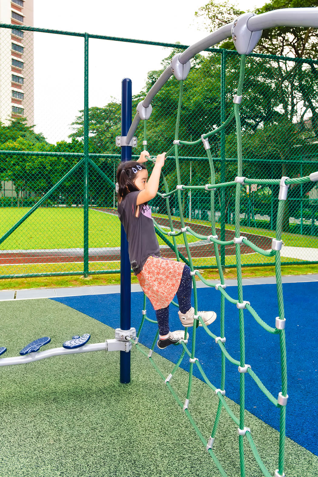 Playworld rope wall with sturdy ropes for climbing, offering vertical and horizontal movement for motor development.