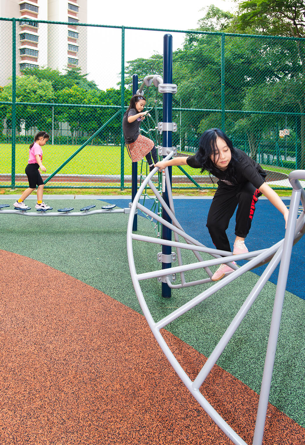 Playworld Helix, a twisting climbing structure, enhances dexterity and body control by navigating its spiral design.