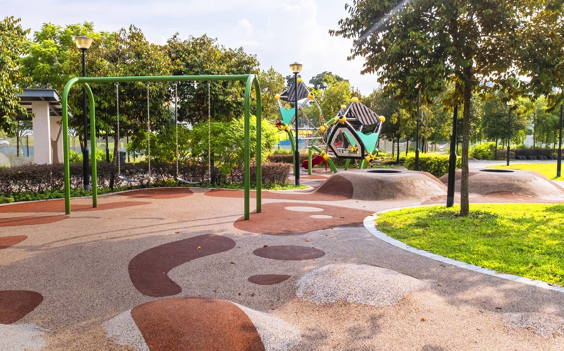 Nim Meadow Park playground with a swing for safe fun and play mounds for active hopping and play.