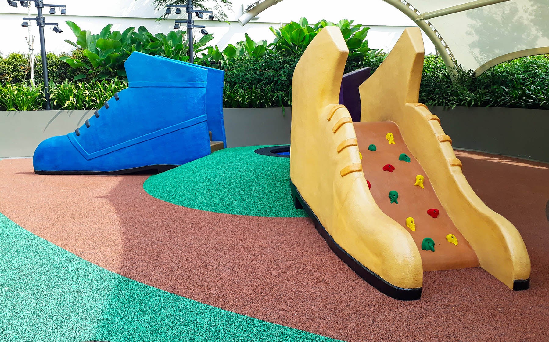 These two small shoe-shaped slides offer children the chance to climb using handgrips, providing fun and challenge.