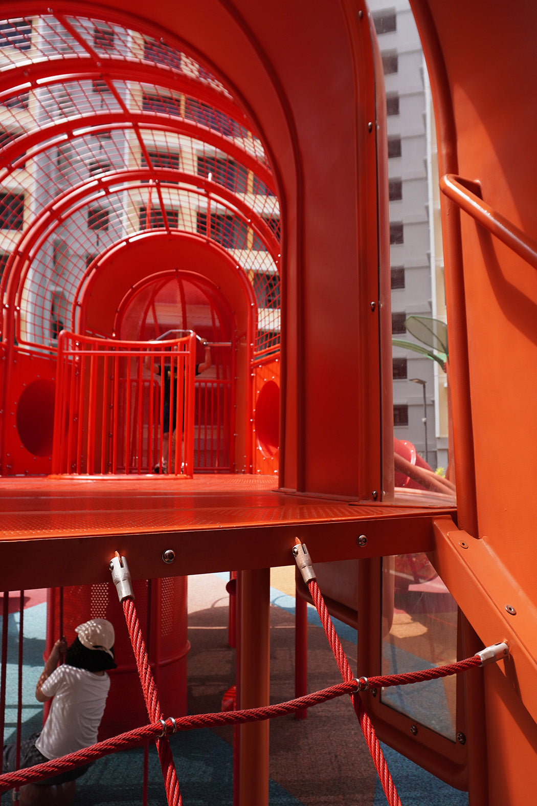 Interior of the lobster-themed playground features dual slides, a vertical shaft and fireman pole for active play.