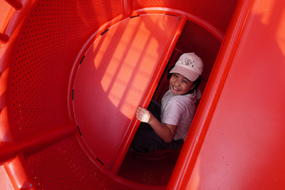 Vertical shaft climbing structure beneath the lobster play tower with stepped access for active movement play.